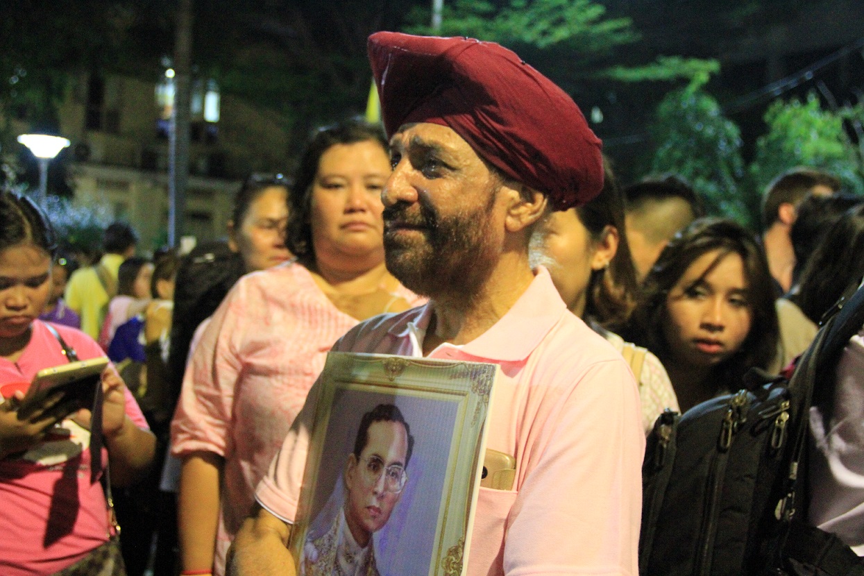 A man weeps outside Siriraj Hospital on the evening of Thursday, Oct. 13, 2016, in Bangkok, where HM King Bhumibol had earlier died.